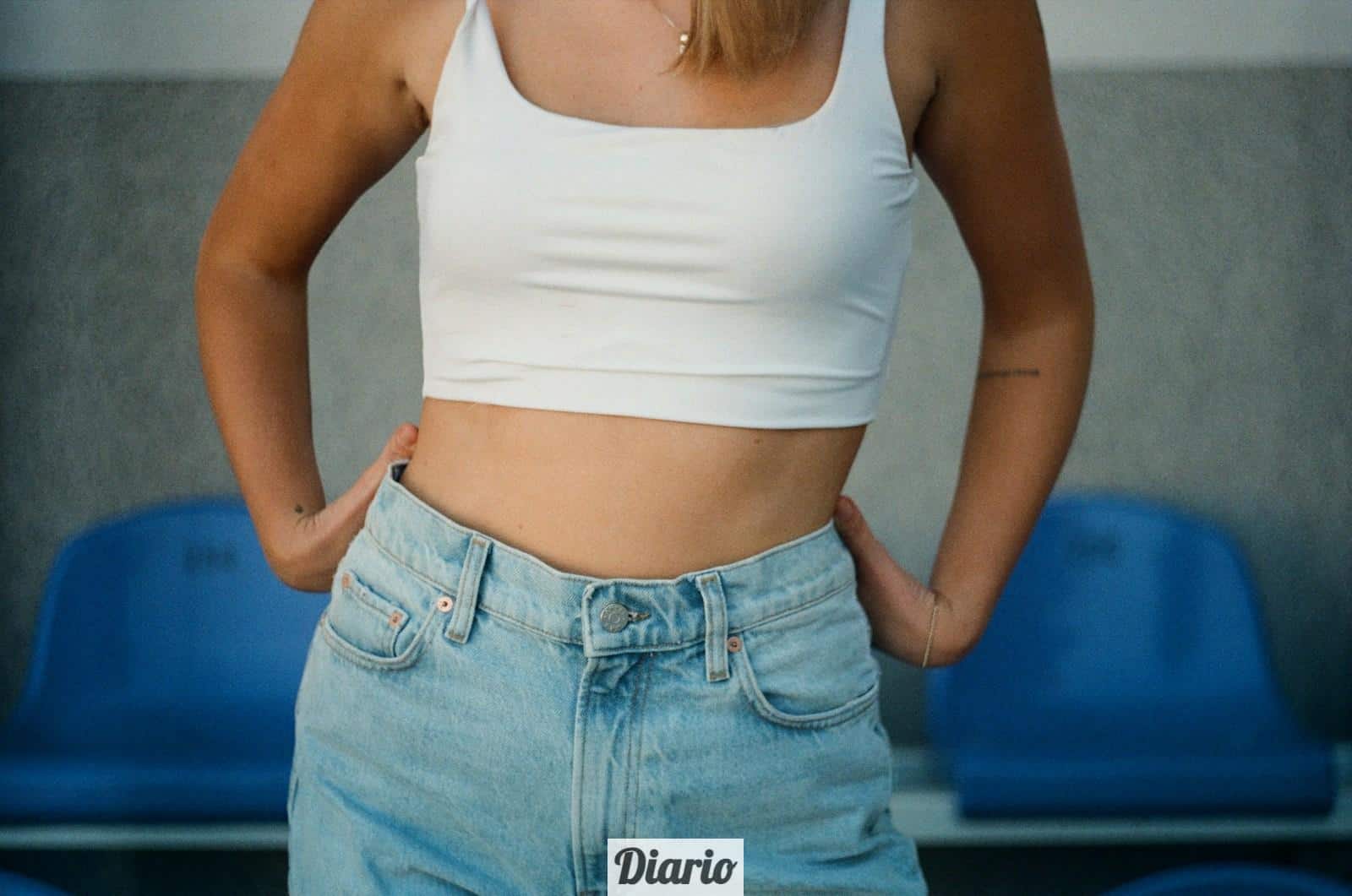 woman in white tank top and blue denim jeans