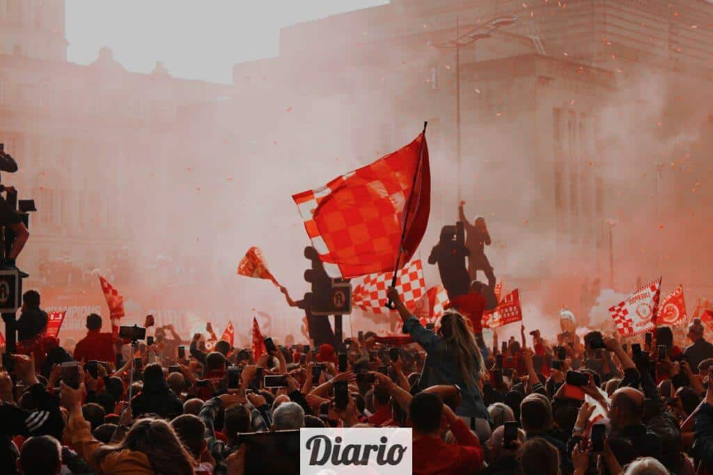 a large crowd of people holding flags and flags